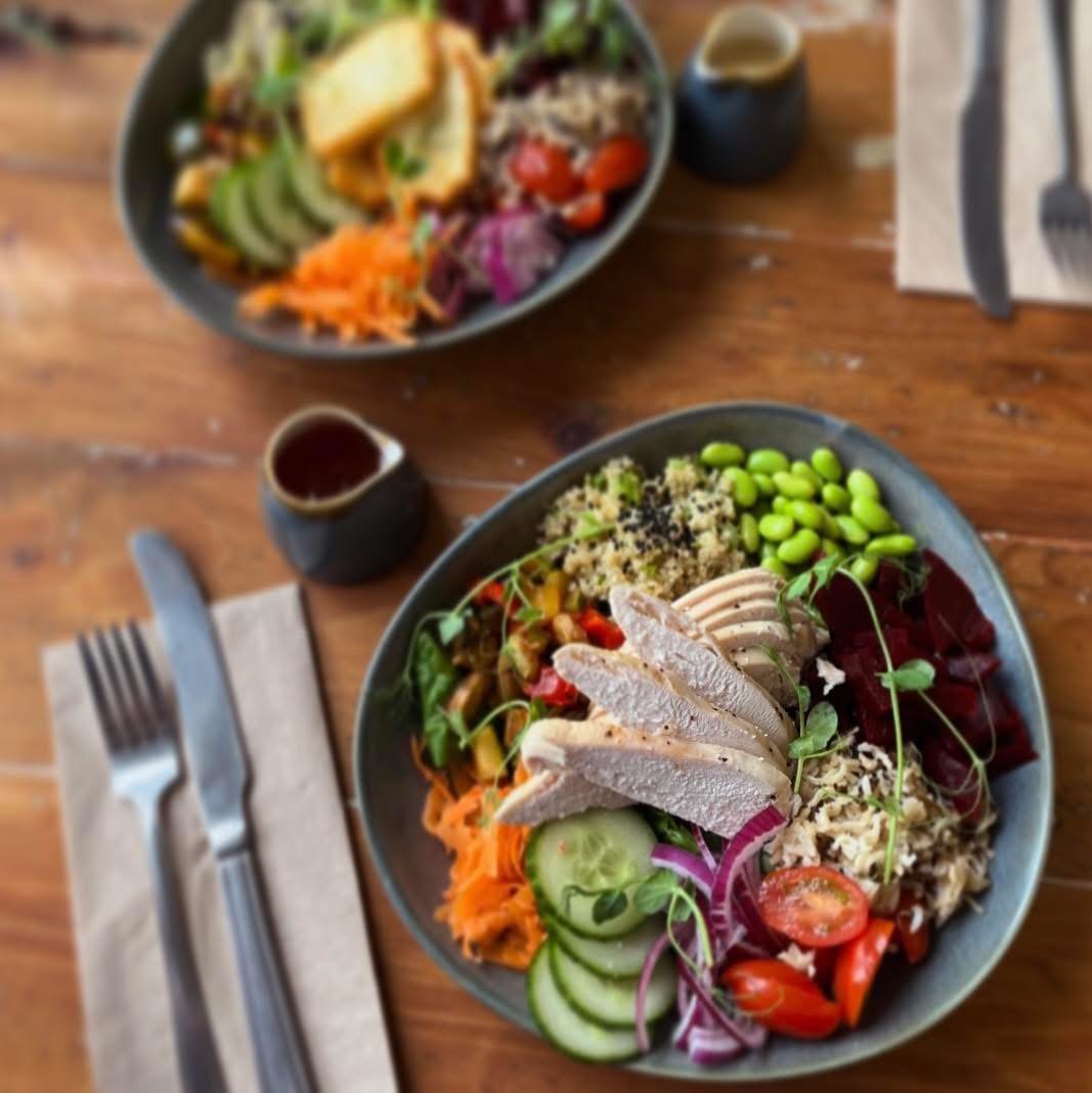 Two protein salad bowls with chicken, vegetables and grains
