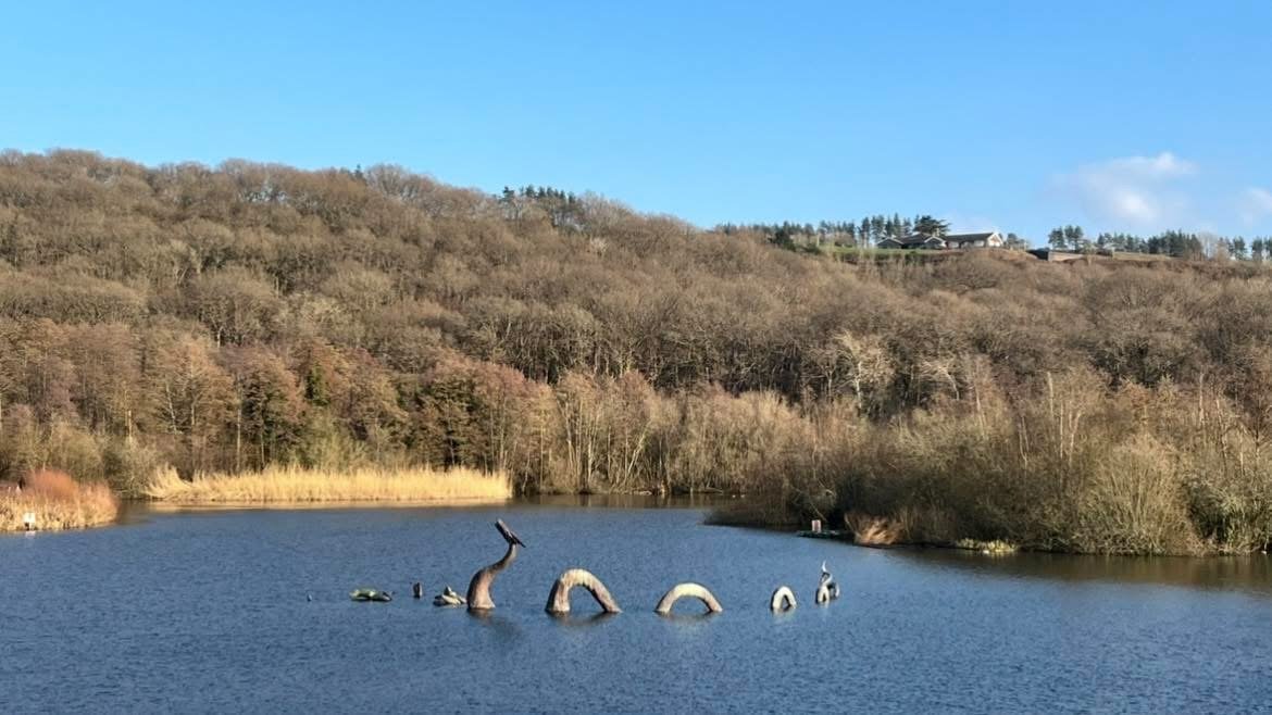 The lake's famous monster sculptures among autumn trees