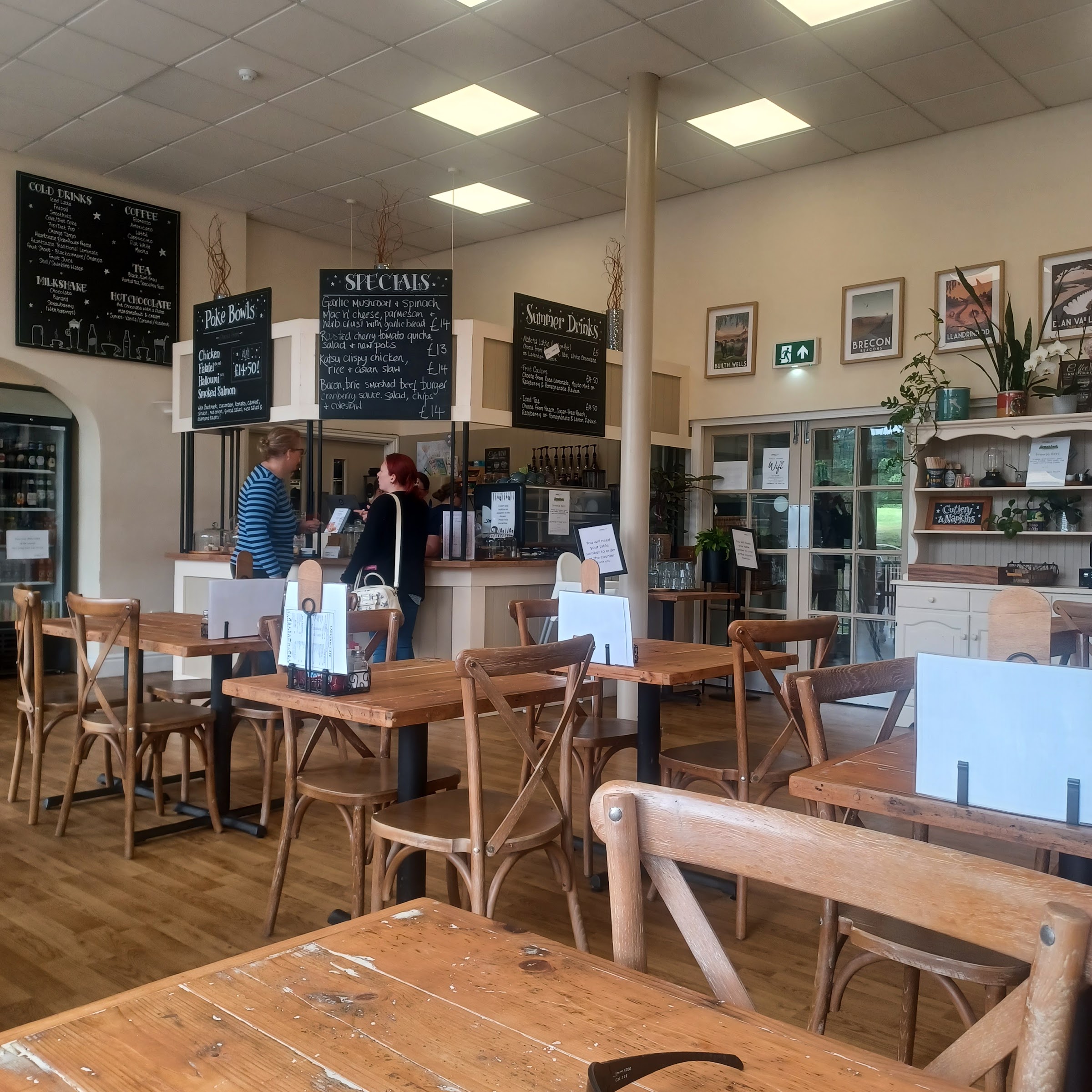 Inside Lakeside Cafe & Catering, showing the counter, menu boards and warm wooden tables
